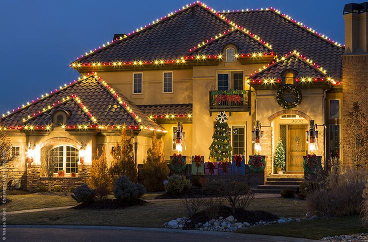 Home with multicolor Christmas roofline lighting.